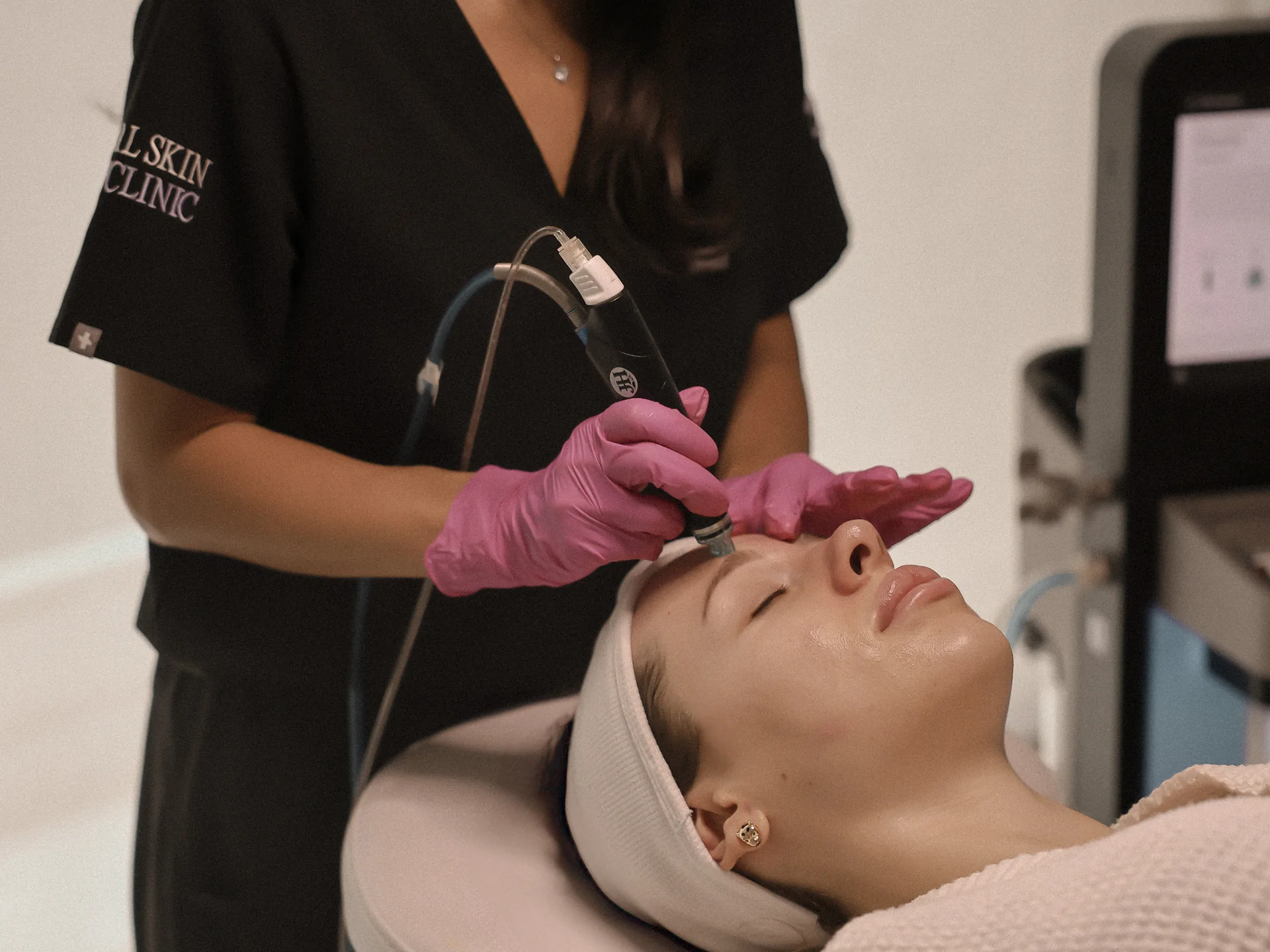 A clinician treating a patient with the HydraFacial handpiece